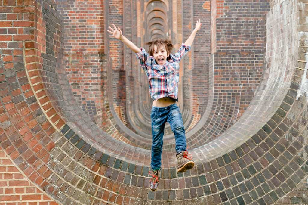 Boy jumping off the arches at Balcombe Viaduct