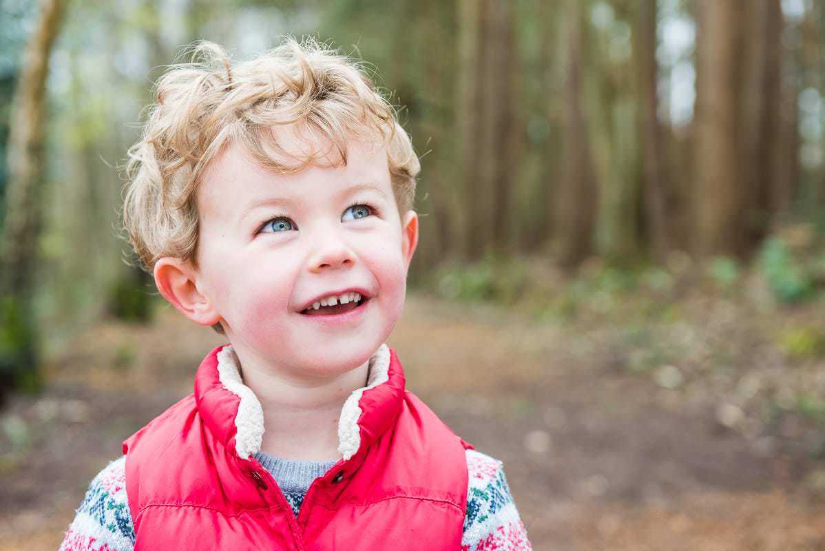 Young boy laughing at the camera during his family photoshoot in Sussex