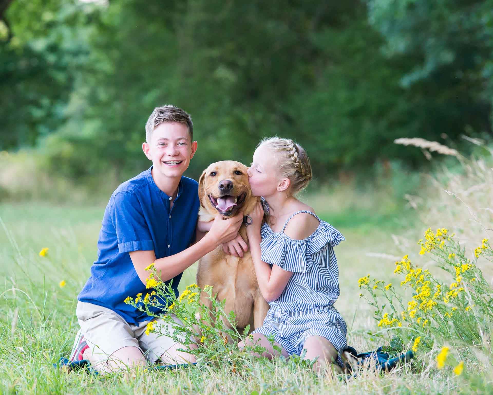 Brother and sister with their dog during a family photoshoot in Sussex
