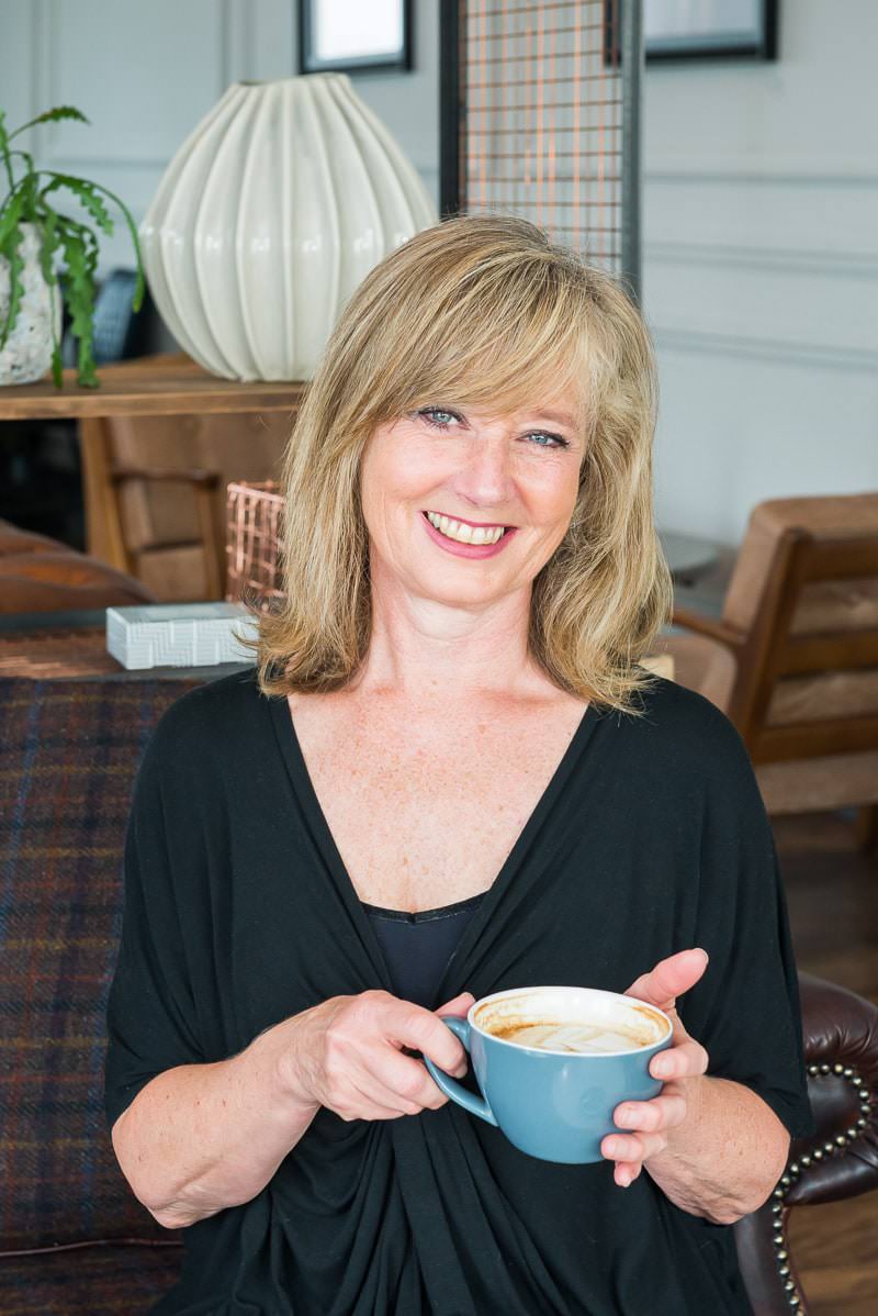 mature lady sitting holding a cup of tea