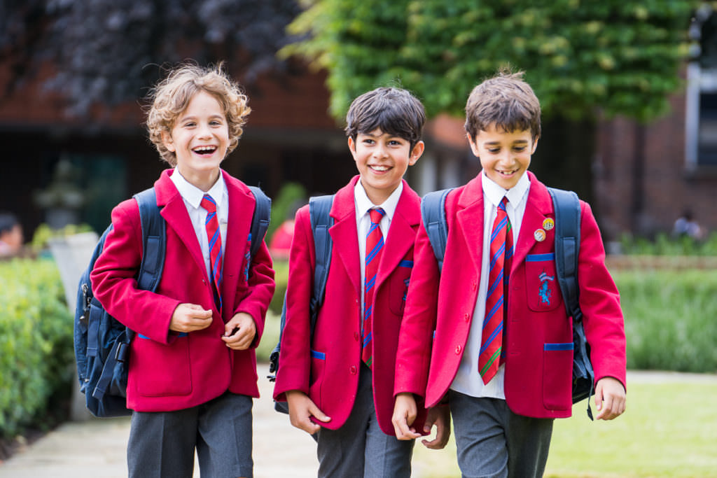 Three school boys walking towards the camera on a school marketing photoshoot