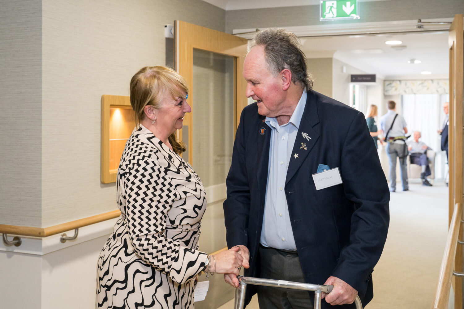 A staff member talks to a resident at the care home opening in Worthing